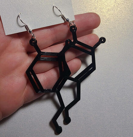 black earrings in the shape of dopamine molecules with silver ear hooks