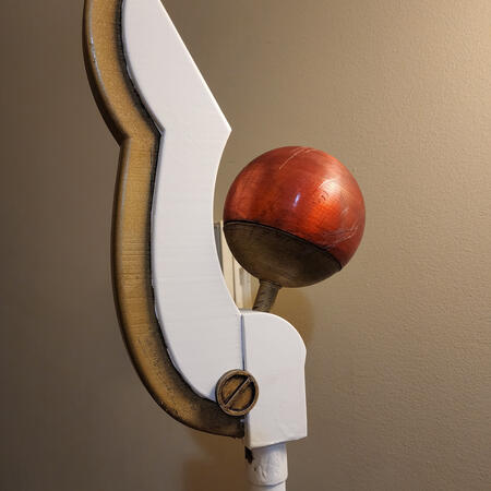 Gold and white single-wing staff with red orb